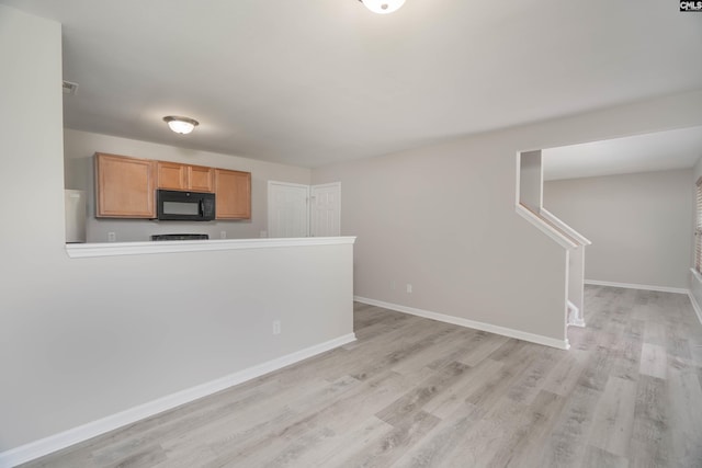 233 Eagle Pointe Dr, Chapin, SC 29036 - kitchen with black microwave, light wood-type flooring, fridge, and light countertops