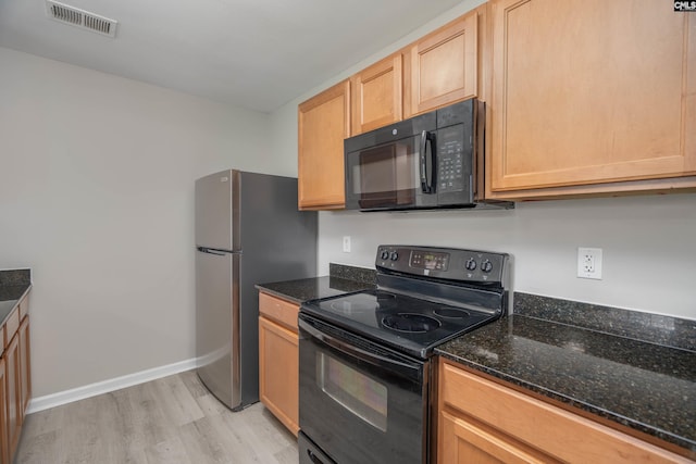 233 Eagle Pointe Dr, Chapin, SC 29036 - kitchen featuring black appliances, light wood-style flooring, dark stone counters, and light brown cabinetry