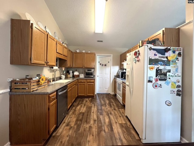213 Rice Hill Ct, Lexington, SC 29072 - kitchen with white appliances, vaulted ceiling, a textured ceiling, dark wood-style flooring, and dark countertops