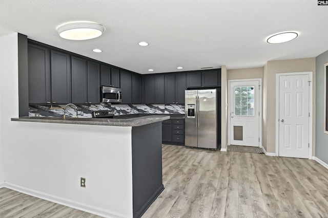 339 Bracken Dr, Lexington, SC 29072 - kitchen with stainless steel appliances, light wood-style flooring, a peninsula, recessed lighting, and tasteful backsplash