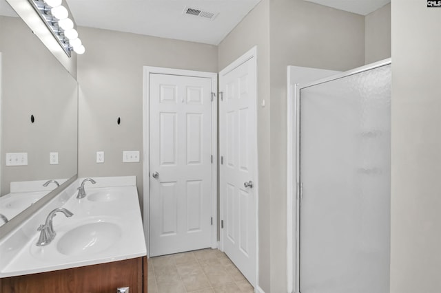 339 Bracken Dr, Lexington, SC 29072 - full bathroom with a shower stall, double vanity, and tile patterned flooring
