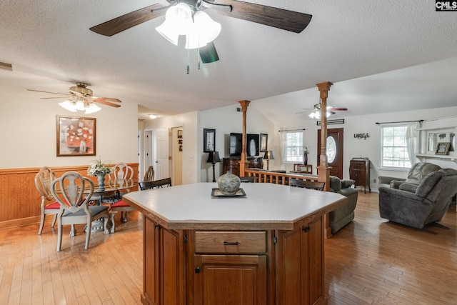 1162 Whippoorwill Rd, Camden, SC 29020 - kitchen with a ceiling fan, open floor plan, brown cabinets, a kitchen island, and light wood-type flooring