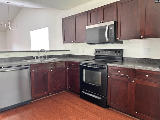 206 Windsor Village Dr, Columbia, SC 29223 - kitchen with stainless steel appliances, dark countertops, dark wood-style flooring, lofted ceiling, and a chandelier