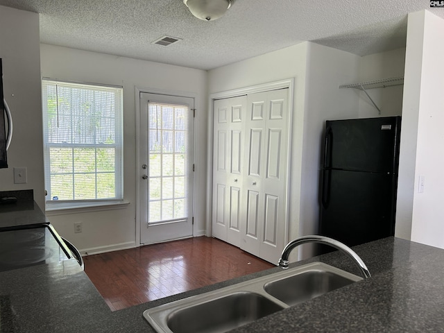206 Windsor Village Dr, Columbia, SC 29223 - kitchen with black appliances, dark wood finished floors, dark countertops, and a textured ceiling