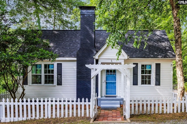 2625 Harrison Rd, Columbia, SC 29204 - view of front facade with a fenced front yard, roof with shingles, and a chimney