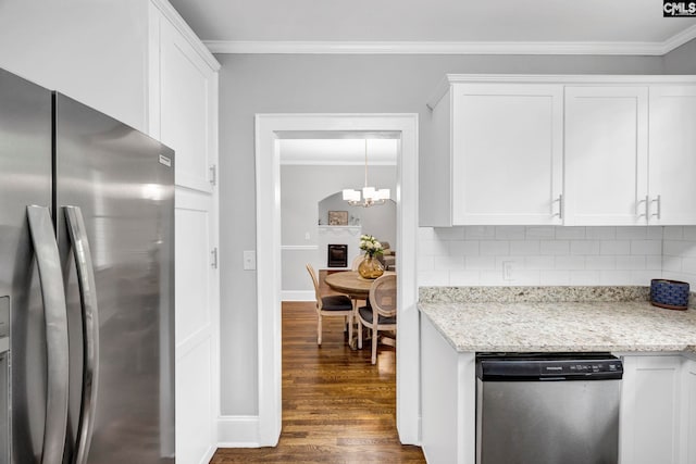 2625 Harrison Rd, Columbia, SC 29204 - kitchen with stainless steel appliances, ornamental molding, dark wood finished floors, backsplash, and white cabinetry