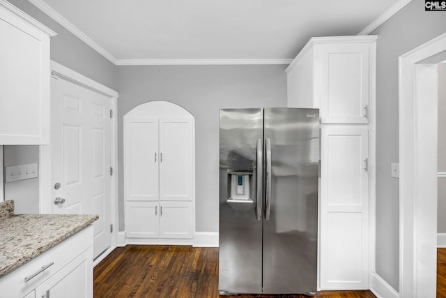 2625 Harrison Rd, Columbia, SC 29204 - kitchen with stainless steel fridge, dark wood-type flooring, light stone counters, white cabinetry, and ornamental molding