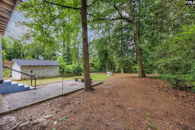 2625 Harrison Rd, Columbia, SC 29204 - view of yard featuring an outdoor structure and view of wooded area