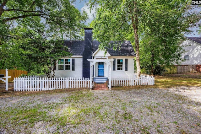 2625 Harrison Rd, Columbia, SC 29204 - view of front facade with a fenced front yard, a chimney, and roof with shingles