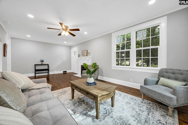 2625 Harrison Rd, Columbia, SC 29204 - living room featuring ceiling fan, recessed lighting, ornamental molding, wood finished floors, and a brick fireplace
