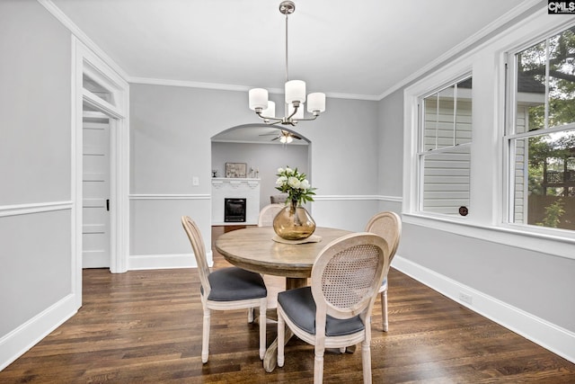 2625 Harrison Rd, Columbia, SC 29204 - dining area with a chandelier, a fireplace, wood finished floors, ornamental molding, and arched walkways