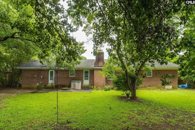 109 Garden Springs Rd, Columbia, SC 29209 - rear view of property featuring brick siding, a lawn, and a chimney