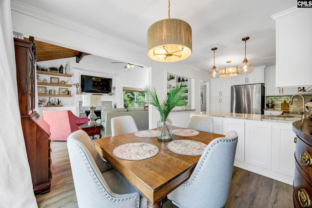 131 Leeward Rd, Columbia, SC 29212 - dining area featuring wood finished floors, crown molding, and a fireplace