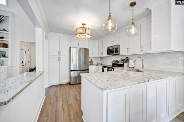 131 Leeward Rd, Columbia, SC 29212 - kitchen featuring appliances with stainless steel finishes, white cabinetry, a peninsula, and decorative backsplash