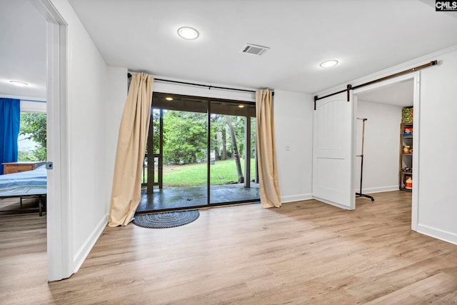 131 Leeward Rd, Columbia, SC 29212 - unfurnished room with a barn door, light wood-type flooring, and recessed lighting