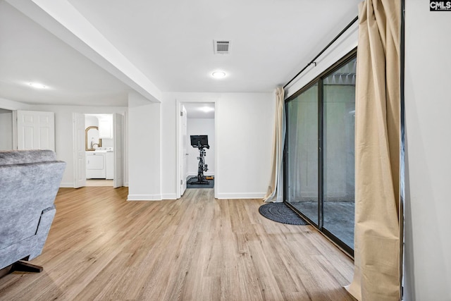 131 Leeward Rd, Columbia, SC 29212 - unfurnished living room with washing machine and dryer and light wood-type flooring