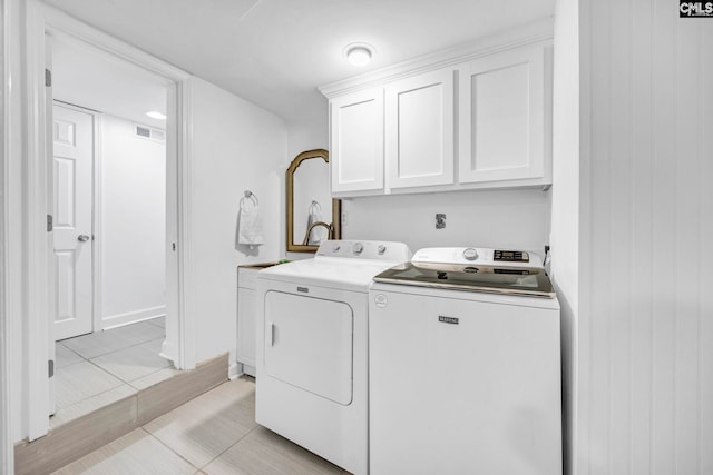 131 Leeward Rd, Columbia, SC 29212 - laundry area featuring washer and clothes dryer, cabinet space, and light tile patterned floors