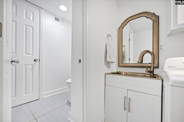131 Leeward Rd, Columbia, SC 29212 - bathroom with washer / clothes dryer, vanity, and tile patterned floors