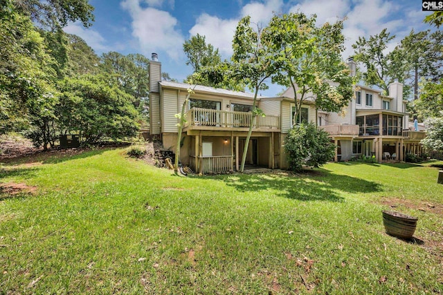 131 Leeward Rd, Columbia, SC 29212 - rear view of house featuring a chimney, a lawn, and a wooden deck