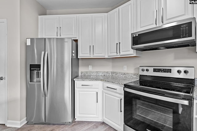 2 Alverston Ct, Irmo, SC 29063 - kitchen with appliances with stainless steel finishes, light wood-type flooring, white cabinetry, and light stone counters