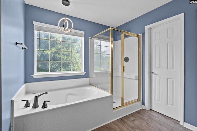 2 Alverston Ct, Irmo, SC 29063 - full bath featuring a stall shower, a garden tub, wood finished floors, and a chandelier