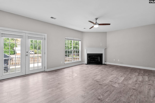 2 Alverston Ct, Irmo, SC 29063 - unfurnished living room with a ceiling fan, wood finished floors, french doors, and a fireplace with flush hearth