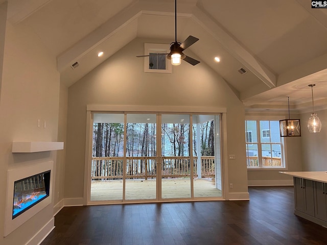 196 Osprey Pointe Ln, Prosperity, SC 29127 - unfurnished living room with dark wood-type flooring, ceiling fan, a glass covered fireplace, high vaulted ceiling, and a chandelier