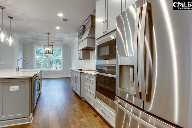 196 Osprey Pointe Ln, Prosperity, SC 29127 - kitchen with appliances with stainless steel finishes, wood-type flooring, a tray ceiling, recessed lighting, and pendant lighting
