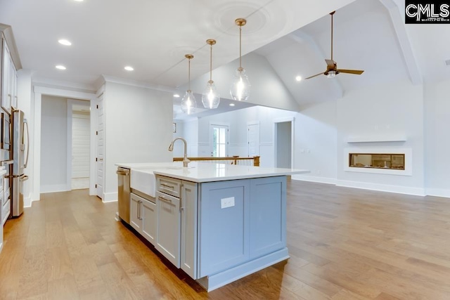 196 Osprey Pointe Ln, Prosperity, SC 29127 - kitchen with ceiling fan, light countertops, light wood-style floors, a kitchen island with sink, and pendant lighting