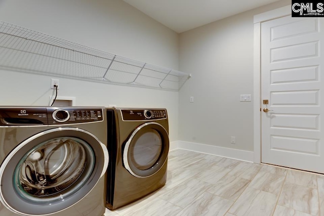 196 Osprey Pointe Ln, Prosperity, SC 29127 - laundry area featuring washing machine and dryer and baseboards