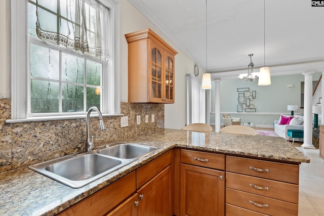 5 Shaftesbury Ln, Columbia, SC 29209 - kitchen featuring crown molding, backsplash, decorative columns, glass insert cabinets, and a peninsula