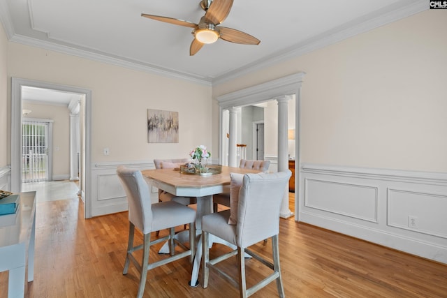5 Shaftesbury Ln, Columbia, SC 29209 - dining area with crown molding, ornate columns, ceiling fan, light wood-style floors, and wainscoting