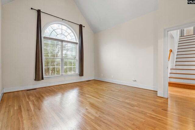 5 Shaftesbury Ln, Columbia, SC 29209 - spare room featuring light wood-type flooring, vaulted ceiling, and stairs