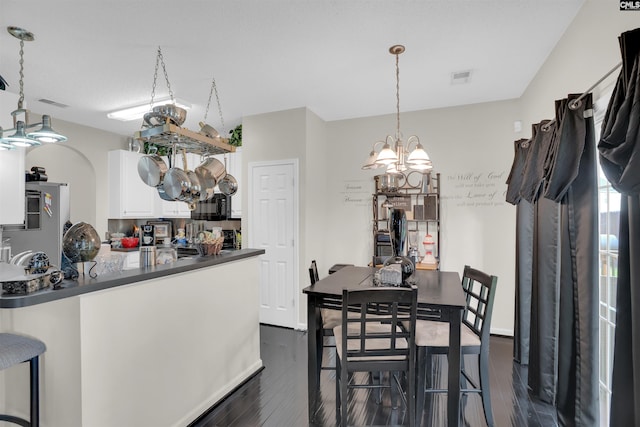 201 Summit Ridge Cir, Columbia, SC 29229 - dining space with a chandelier, dark wood-style floors, and arched walkways