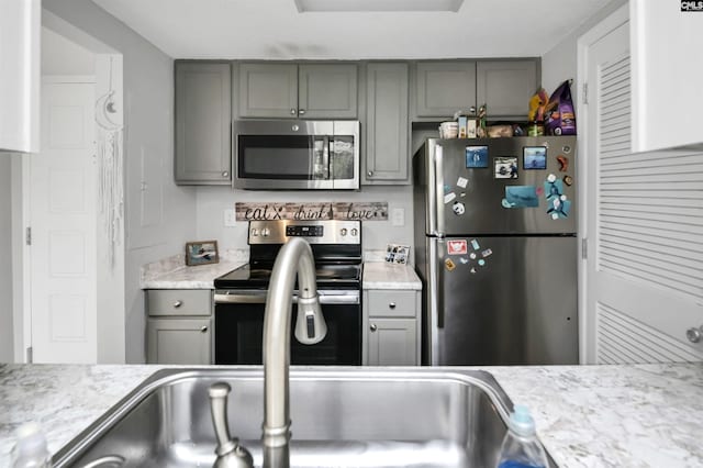 1100 Wheat St Unit 510, Columbia, SC 29201 - kitchen featuring stainless steel appliances, gray cabinetry, and light countertops