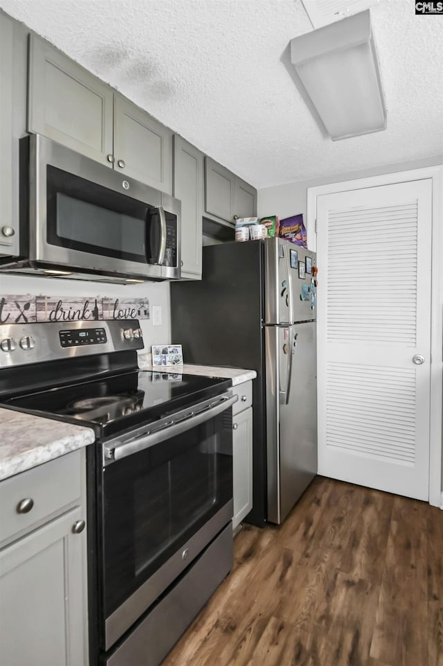1100 Wheat St Unit 510, Columbia, SC 29201 - kitchen featuring appliances with stainless steel finishes, dark wood-type flooring, gray cabinetry, and a textured ceiling