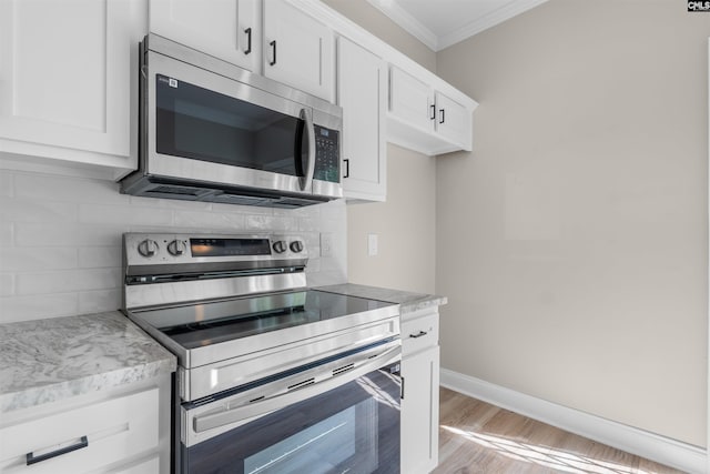 232 Burbank St, Columbia, SC 29210 - kitchen with appliances with stainless steel finishes, ornamental molding, decorative backsplash, and white cabinets