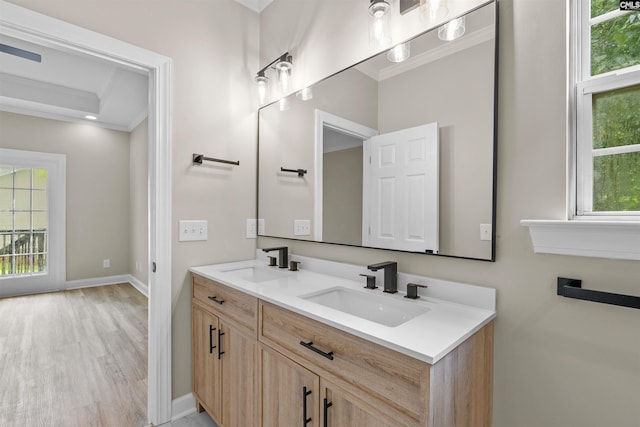 232 Burbank St, Columbia, SC 29210 - bathroom featuring crown molding, double vanity, and wood finished floors