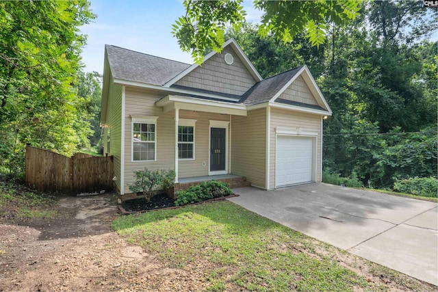 232 Burbank St, Columbia, SC 29210 - view of front of house with concrete driveway, a garage, a shingled roof, and covered porch