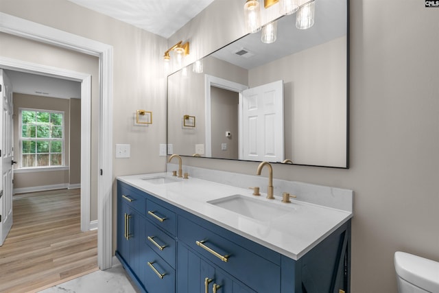 232 Burbank St, Columbia, SC 29210 - bathroom featuring double vanity and wood finished floors