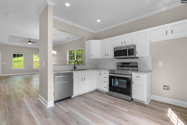 232 Burbank St, Columbia, SC 29210 - kitchen featuring stainless steel appliances, light wood finished floors, backsplash, a ceiling fan, and light stone counters