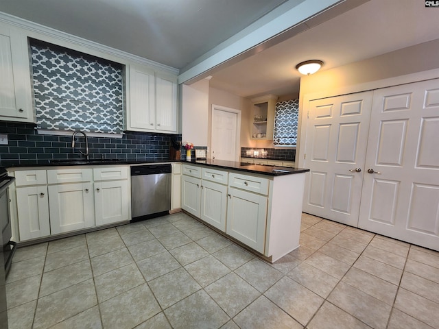 334 Gaffney St, West Columbia, SC 29169 - kitchen with stainless steel dishwasher, light tile patterned floors, decorative backsplash, dark countertops, and a peninsula