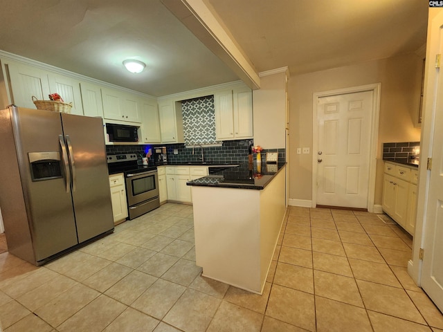 334 Gaffney St, West Columbia, SC 29169 - kitchen featuring appliances with stainless steel finishes, a peninsula, tasteful backsplash, light tile patterned flooring, and crown molding