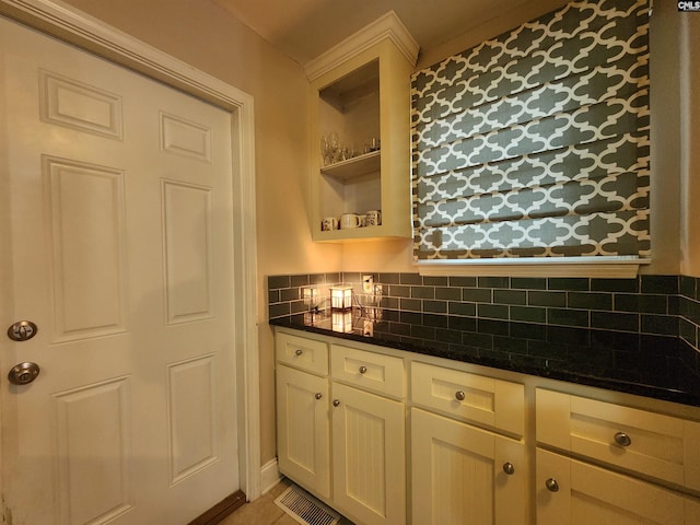 334 Gaffney St, West Columbia, SC 29169 - kitchen featuring decorative backsplash, dark stone countertops, white cabinets, and open shelves