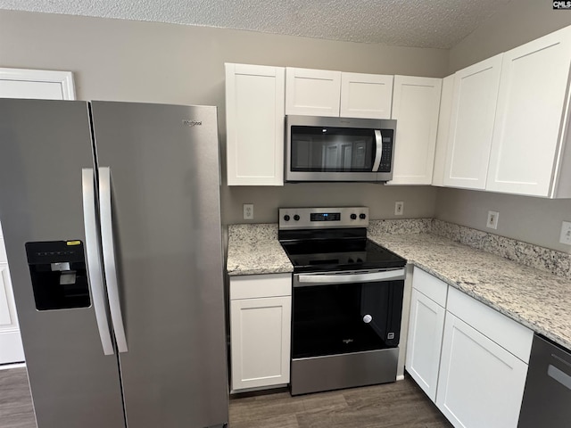 220 Sterling Cross Dr, Columbia, SC 29229 - kitchen with stainless steel appliances, dark wood-style floors, white cabinetry, a textured ceiling, and light stone countertops