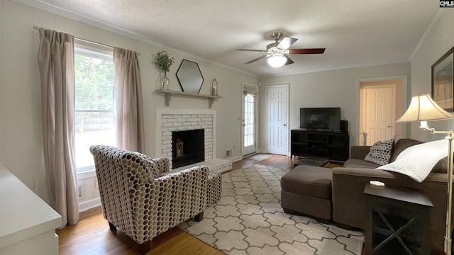 6965 Shelley Rd, Columbia, SC 29209 - living room featuring ornamental molding, wood finished floors, a ceiling fan, and a fireplace