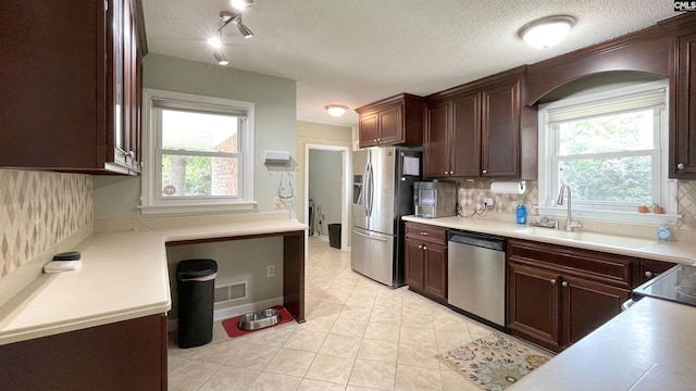 6965 Shelley Rd, Columbia, SC 29209 - kitchen featuring stainless steel appliances, tasteful backsplash, light countertops, and light tile patterned floors