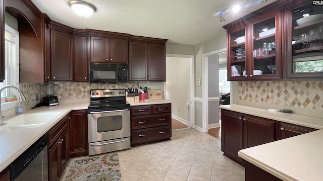 6965 Shelley Rd, Columbia, SC 29209 - kitchen with appliances with stainless steel finishes, light countertops, decorative backsplash, and glass insert cabinets
