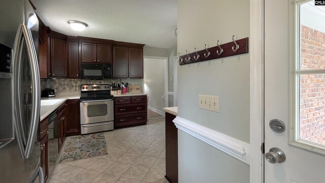 6965 Shelley Rd, Columbia, SC 29209 - kitchen featuring stainless steel appliances, tasteful backsplash, light countertops, light tile patterned flooring, and dark brown cabinetry