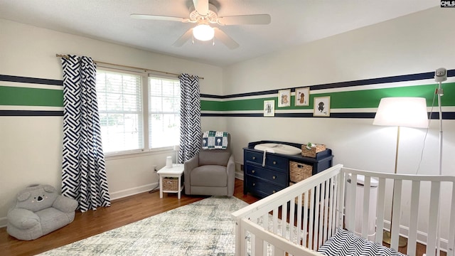 6965 Shelley Rd, Columbia, SC 29209 - bedroom with wood finished floors, a nursery area, and a ceiling fan